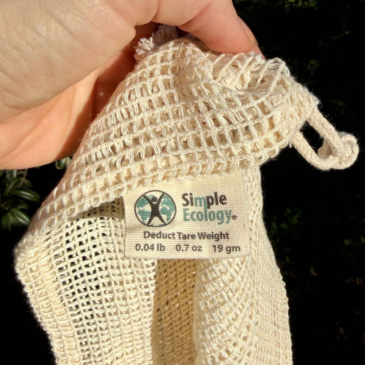 Close up of cotton mesh produce bag weave and tare label 
