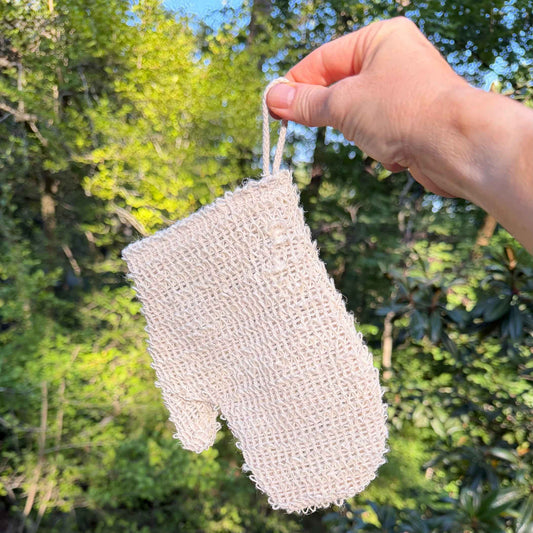 Natural sisal exfoliating shower glove held by its cotton loop