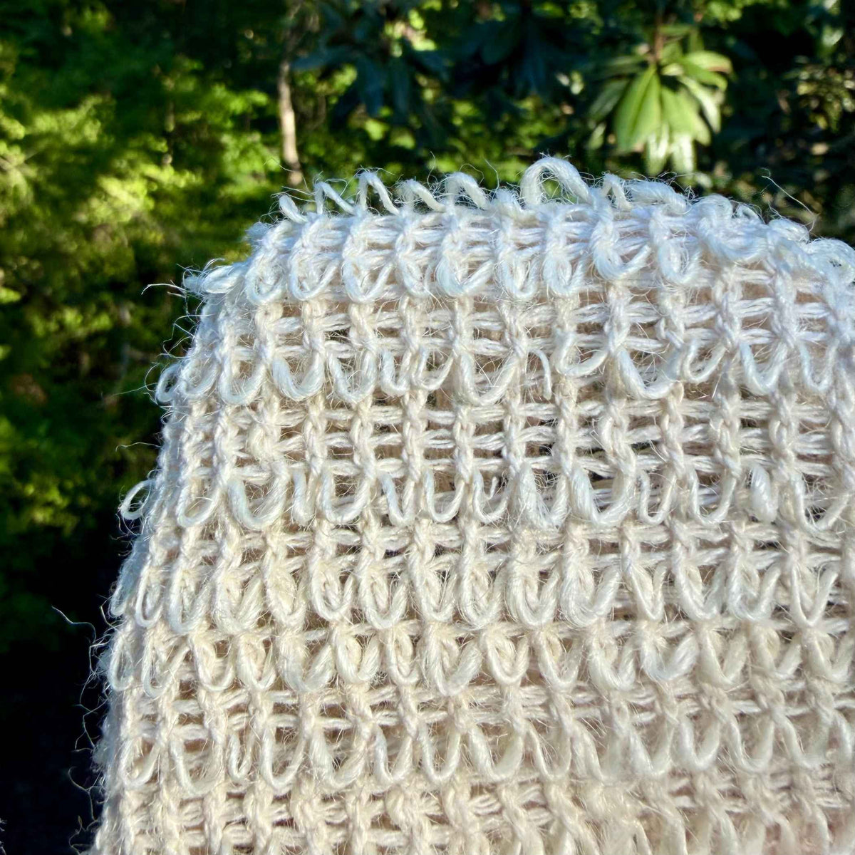 Close-up of natural sisal fiber weave texture on exfoliating shower glove
