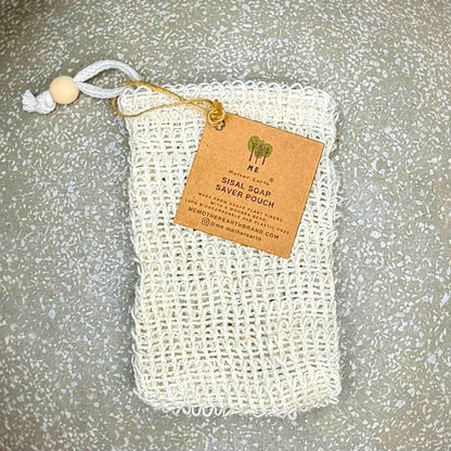 Natural sisal soap saver pouch with a wooden bead drawstring and a brown kraft paper product tag.