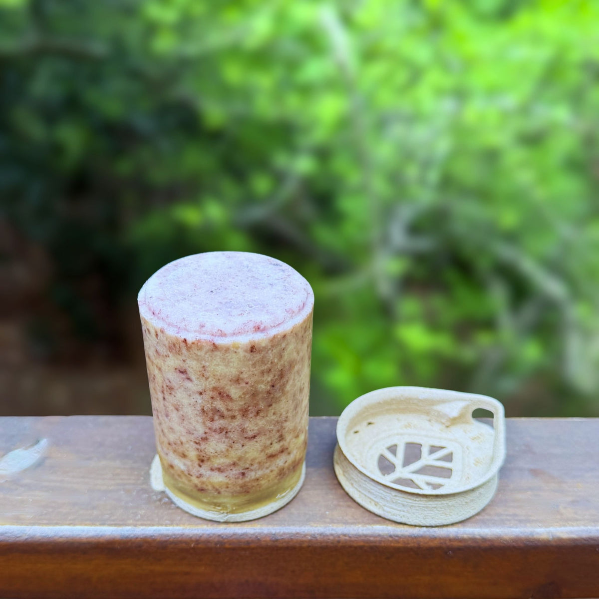 Stem Lavender Romarin shampoo bar with  cap sitting next to it, showing beeswax coating in detail