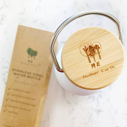 Top-down view of an engraved bamboo water bottle lid with a metal handle next to its brown kraft paper packaging box.