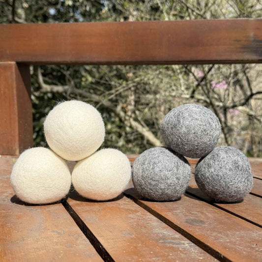 Six organic New Zealand wool dryer balls, three white and three gray